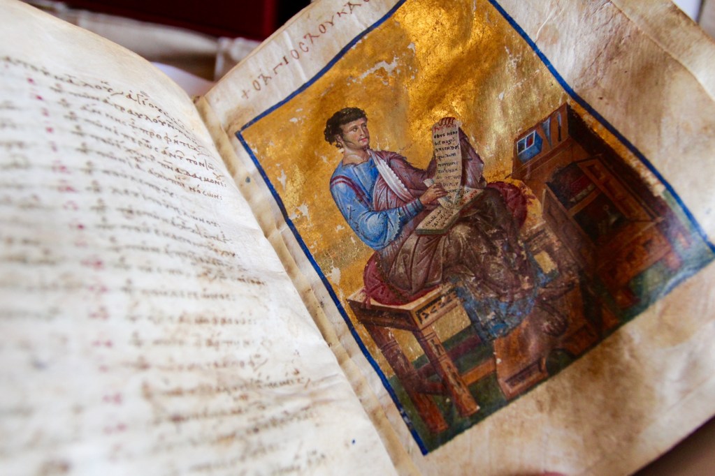 Open manuscript picturing portrait of Matthew, Gospel author.