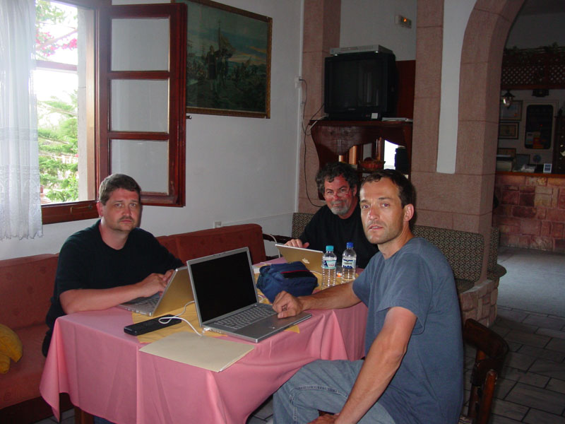 Three CSNTM team members working at a table. 